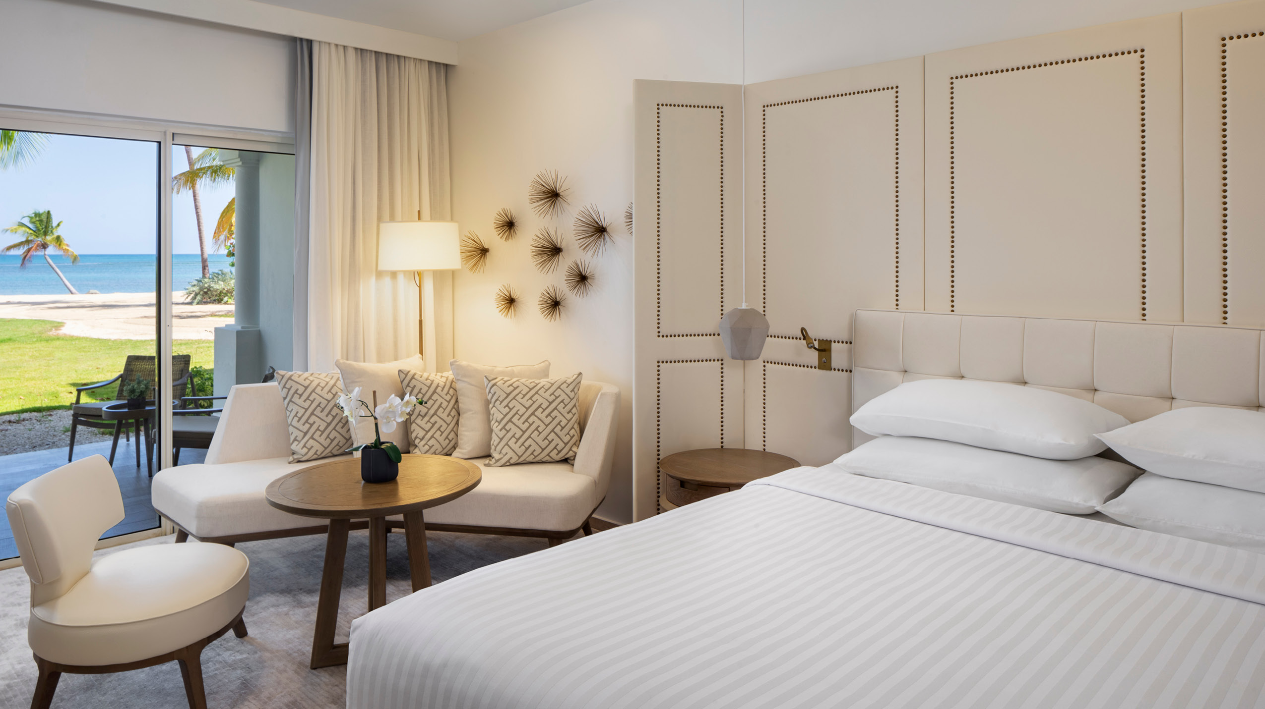 Oceanfront hotel room at the Hyatt Regency Grand Reserve, showcasing a seamless blend of comfort and style with beach views and access to the patio.